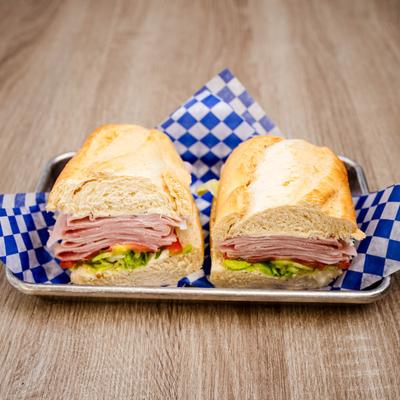 Ham sandwich with lettuce and tomato.