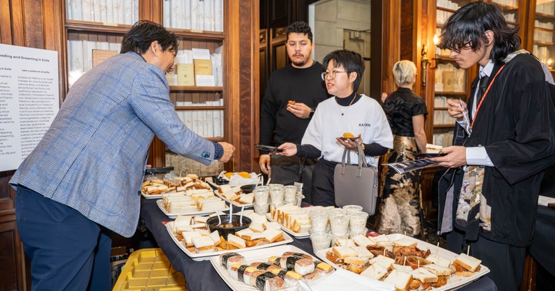 People gathering around a catered buffet table