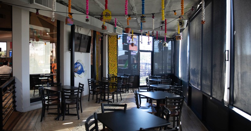 Interior, tables, chairs, hanging decorations, windows, glass doors