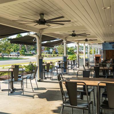 Tables and chairs outside on the covered patio.