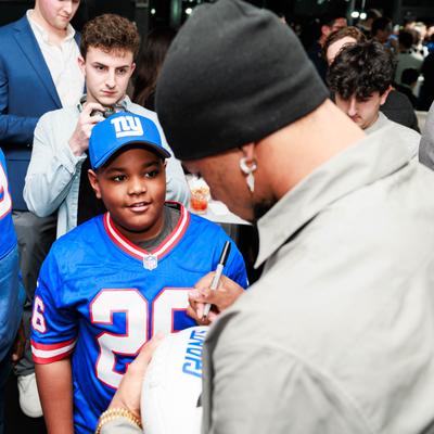 Signing autograph on a football jersey.