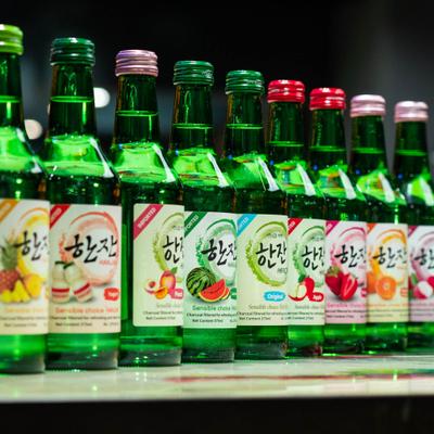 Flavored soju bottles lined on a counter.