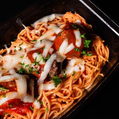 Bison meatballs with thin noodles, close up.