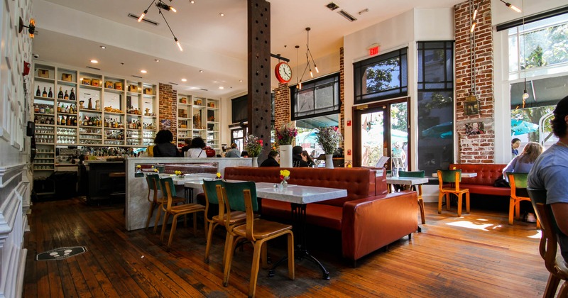 Interior, tables, chairs and brown high back leather seating
