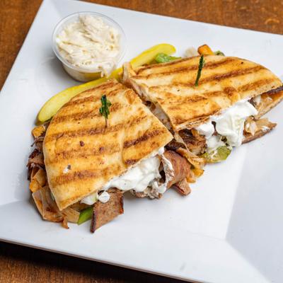 Panini with gyro, cooked onions & peppers, and mozzarella.