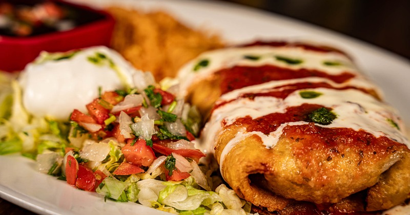 Chimichanga, with lettuce, pico de gallo, and sour cream