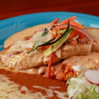 Pastry with melted cheese, mixed salad and rice on the side