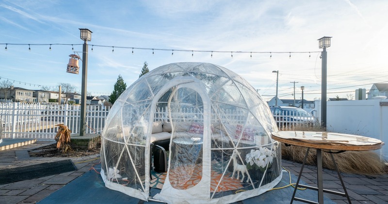 Exterior, dome shaped outdoor dining igloo, arched banquette bench with coffee table