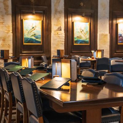 Elegant restaurant dining table with menus and small lamps.