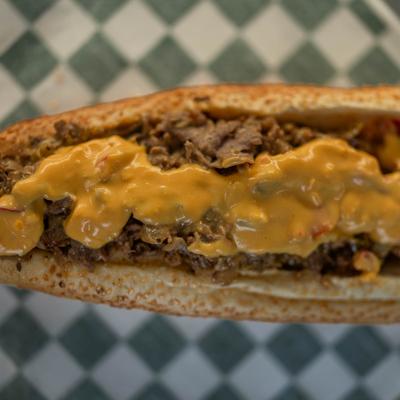 Pepper jawn cheesesteak sandwich topped with melted cheese.