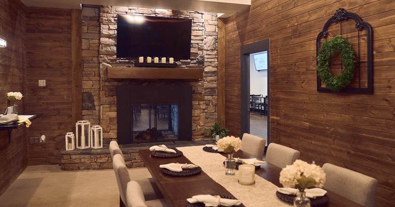 Interior, private room with the TV on the wall and table for eight