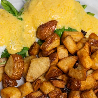 Eggs Florentine with breakfast potatoes.