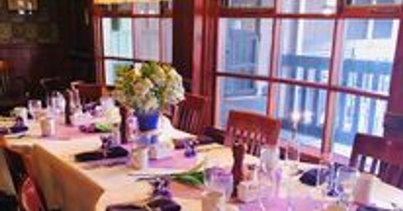 Interior, a table set and decorated for  an elegant dining experience