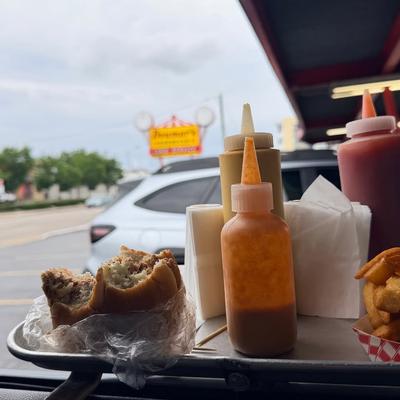 Tray of food hanging from a car's window in our curb service area.  Doumar's sign in the background..