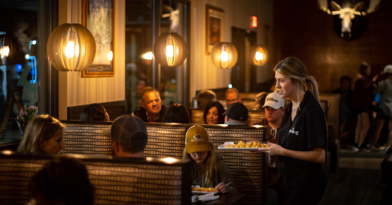 An employee serving food to guests