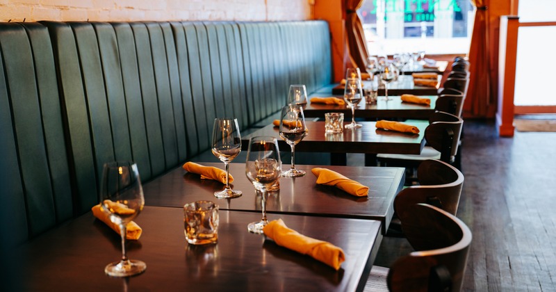 Lined up dining tables set for guests, close up