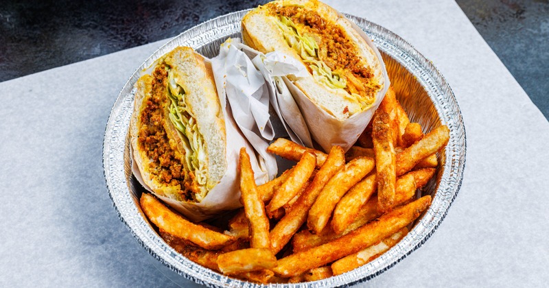 Chop Cheese sandwich with a side of fries