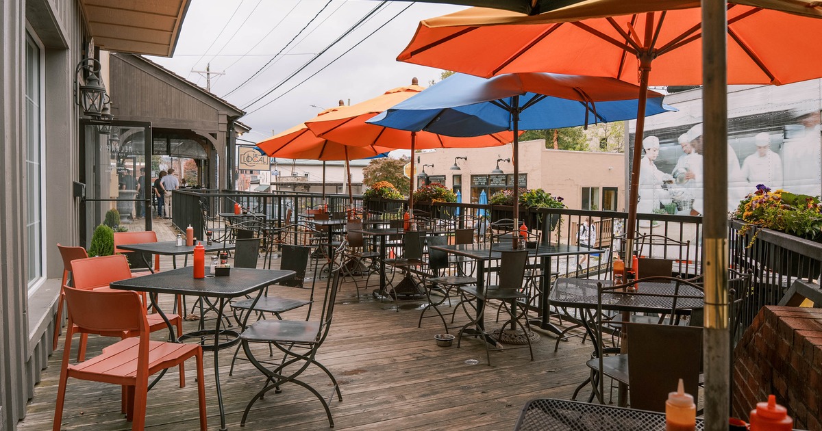 Outdoor restaurant patio with tables, chairs and colorful umbrellas