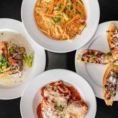 Multiple food plates viewed from top.