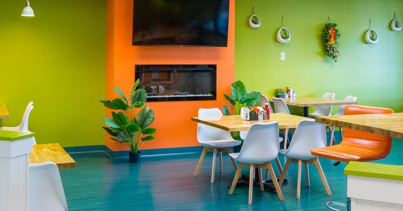 Interior, modern tables and seats, plant pots, a wall TV