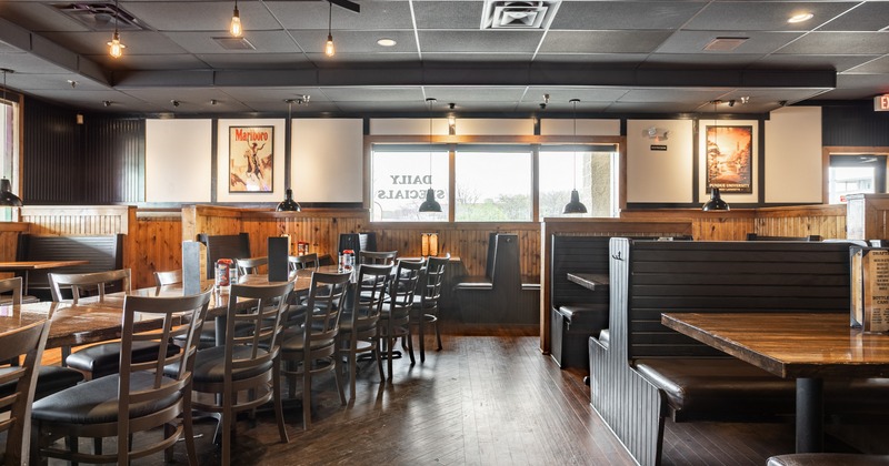 Interior, dining space with wooden floors, booths, tables and chairs