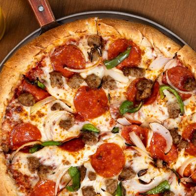 Pizza with pepperoni, Italian sausage, green peppers, and onions.