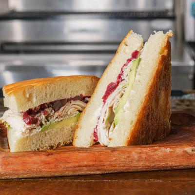 Turkey sandwich, with avocado, mayo, and cranberry sauce.