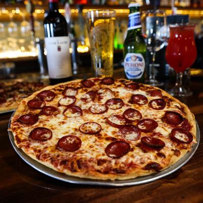 Pizza with pepperoni, salami, ham, sausage, red onion, black olives, and mushrooms.