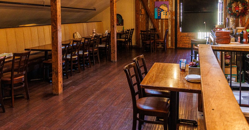 Interior with wooden floor and wooden tables and chairs.