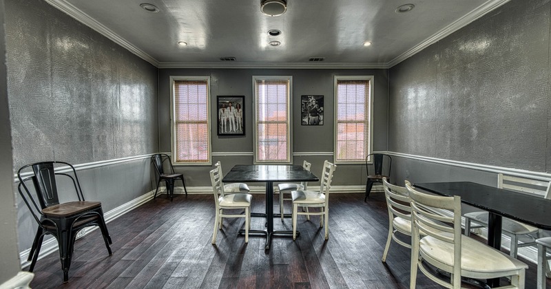A small room with a black rectangular table, six chairs