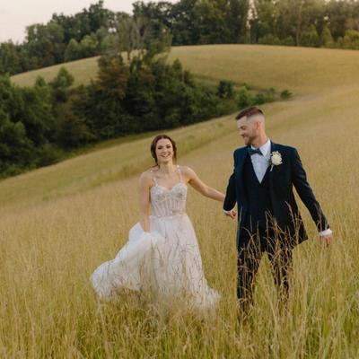 The bride and groom walking hand in hand.