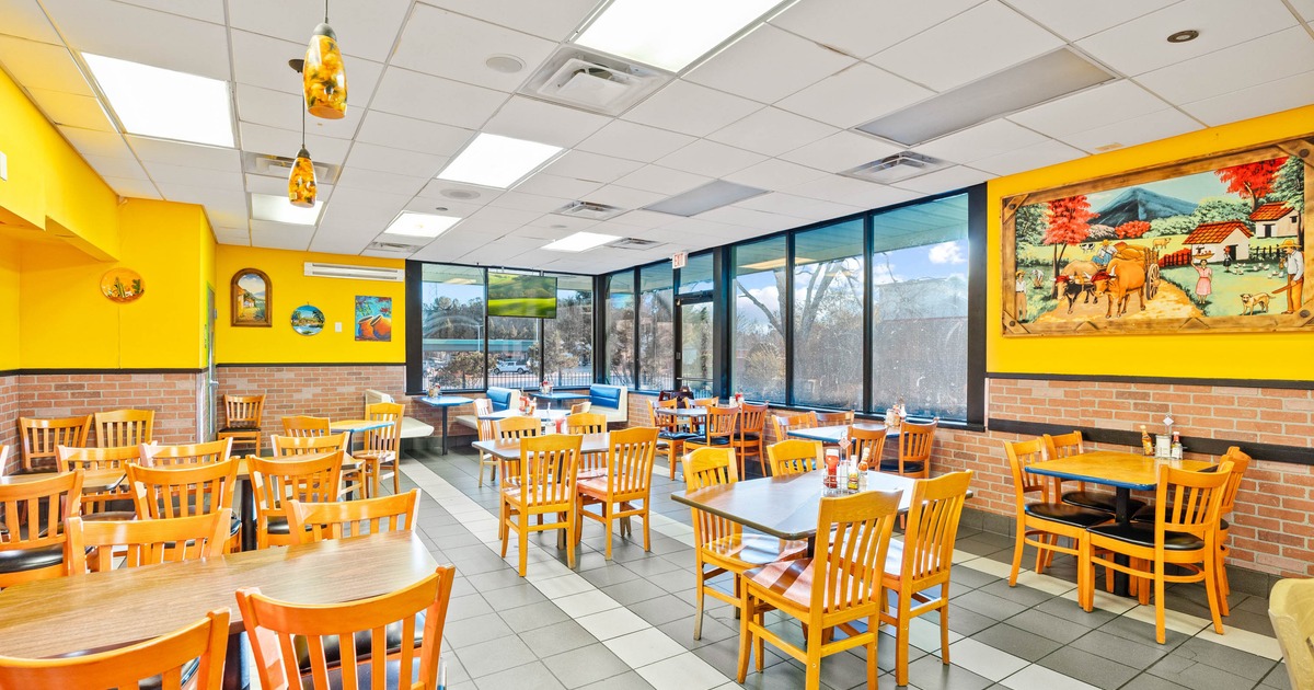 Interior, dining area, wooden top tables with wooden chairs, entrance, shop window