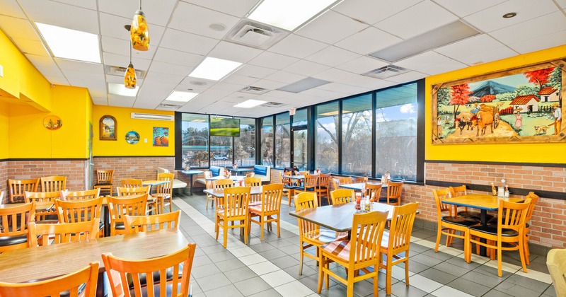Interior, dining area, wooden top tables with wooden chairs, entrance, shop window