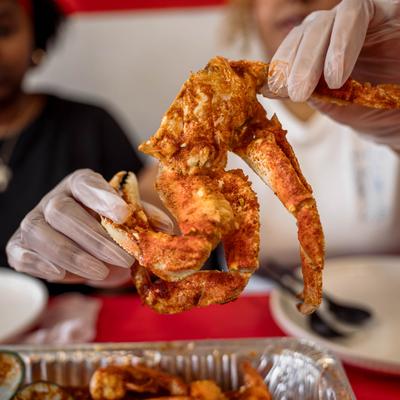 Hands holding seafood.