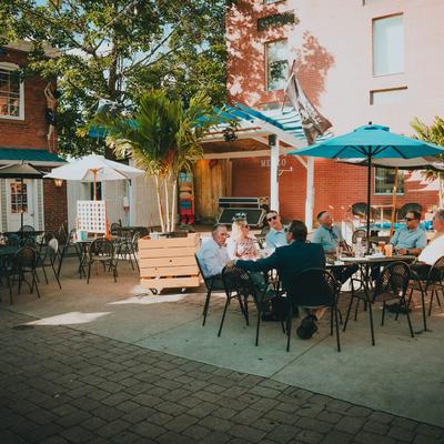 Exterior, guests relaxing in the outdoor seating area.