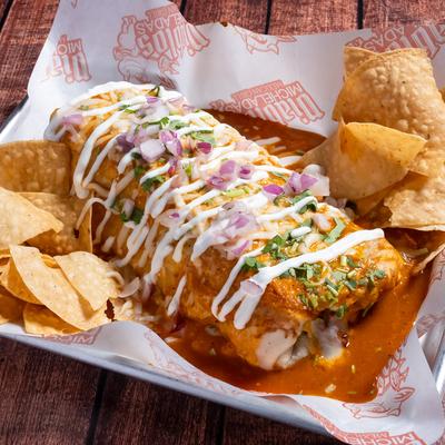 Wet burrito accompanied by tortilla chips.