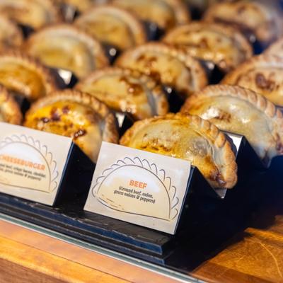 Variety of Argentine-style empanadas displayed on a counter.