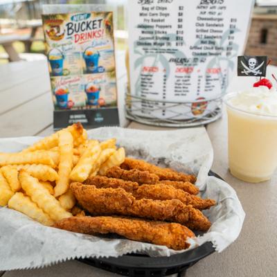 Chicken tenders served with crinkle-cut fries and a drink.