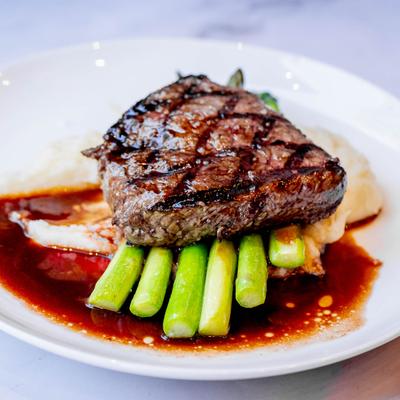 Grilled steak with asparagus and mashed potatoes in red wine sauce.