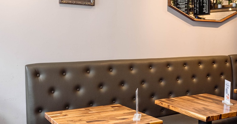 Interior, tables and chairs with mirrors on the wall