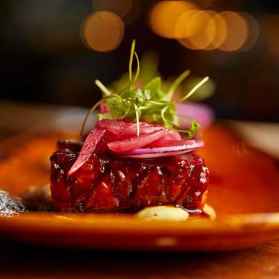 Glazed pork belly bite, closeup.