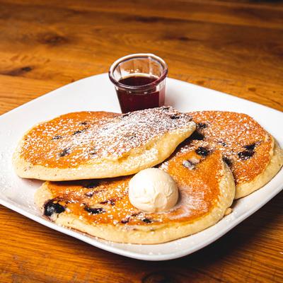 Lemon-Berry Ricotta Pancakes with maple syrup on the side.