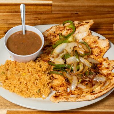 Grilled chicken breast with grilled onions, peppers, rice, and beans.