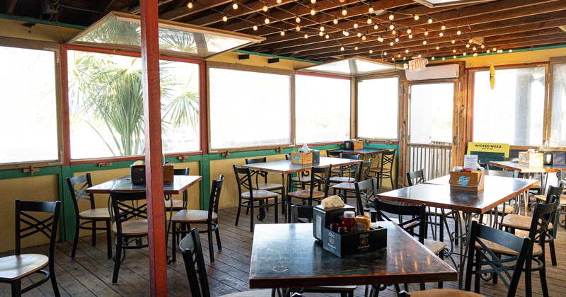 Interior, tables, chairs, lighting, windows, a door