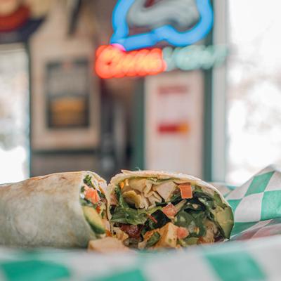 Gladiator wrap with chicken breast, avocado, vegetables and sweet jalapeno sauce