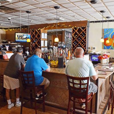 Guests sit at the bar and drink.