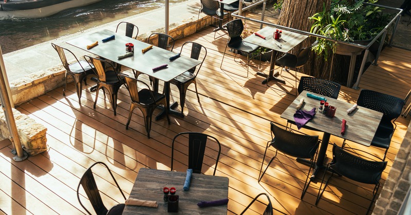 Cozy outdoor dining area with dining tables set for guests