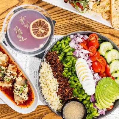 Cobb salad accompanied by dumplings and a lavender martini.