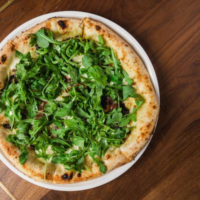 Tartufo pizza, with mixed cheeses, mushrooms, roasted garlic, and arugula