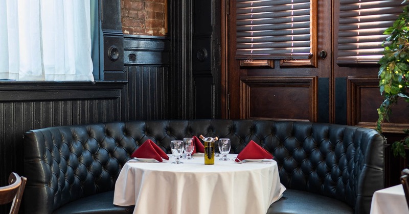 Interior, leather booth, table served for guests